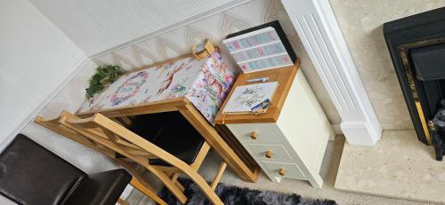 a room with a bed and a table with a drawer at Barton Beach First Floor Holiday Apartment Mablethorpe in Mablethorpe