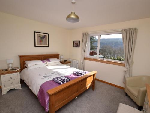 a bedroom with a bed and a window at 3 Bed in Inverness oc-in633 in Balnain