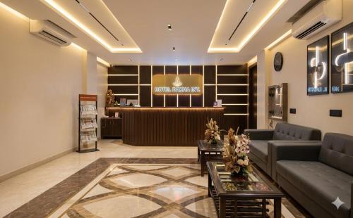 a lobby with a couch and a bar in the background at HOTEL DAKHA INTERNATIONAL - Karol Bagh, New Delhi in New Delhi