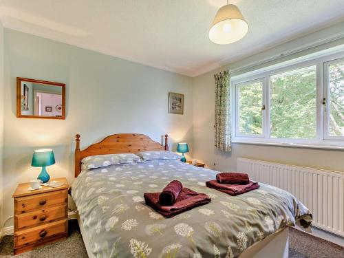 a bedroom with a bed with two towels on it at 3 Bed in Keswick oc-sz047 in Threlkeld