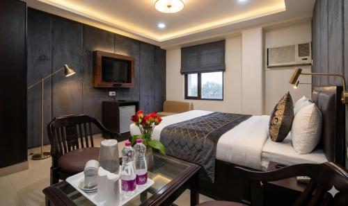 a hotel room with a bed and a table at HOTEL DAKHA INTERNATIONAL - Karol Bagh, New Delhi in New Delhi