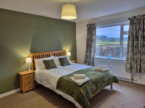 a bedroom with a bed and a large window at 3 Bed in Dumfries oc-77430 in Auldgirth