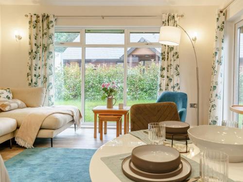 a living room with a couch and a table at 2 Bed in Swansea oc-91725 in Killay