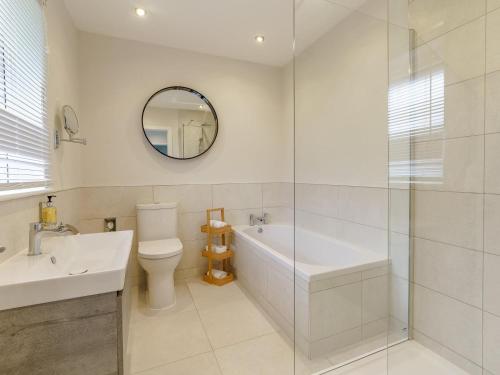 a bathroom with a tub and a toilet and a sink at 2 Bed in Swansea oc-91725 in Killay