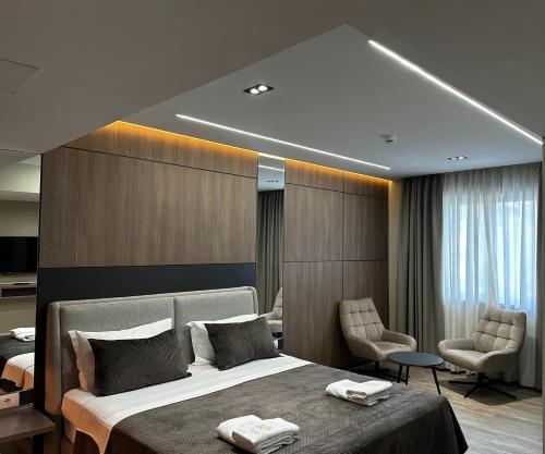 a bedroom with a large bed with two towels on it at Hotel Liss in Lezhë