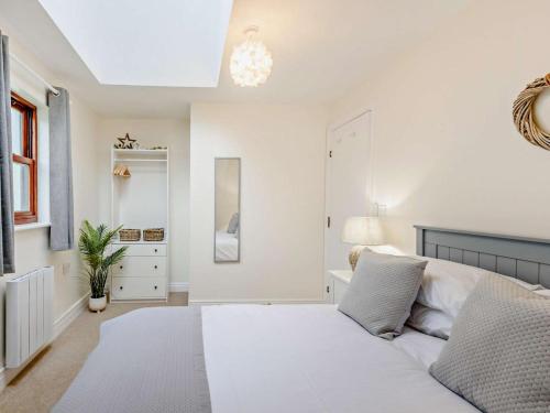 a white bedroom with a bed and a window at 2 Bed in Keswick oc-91901 in Keswick