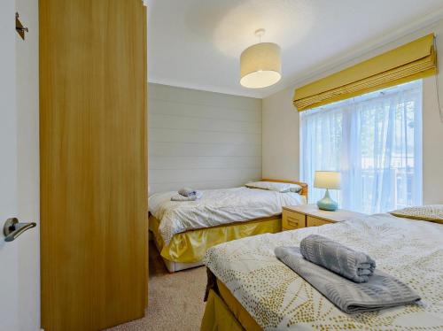 a bedroom with two beds and a window at 2 Bed in Narberth oc-91799 in Stepaside