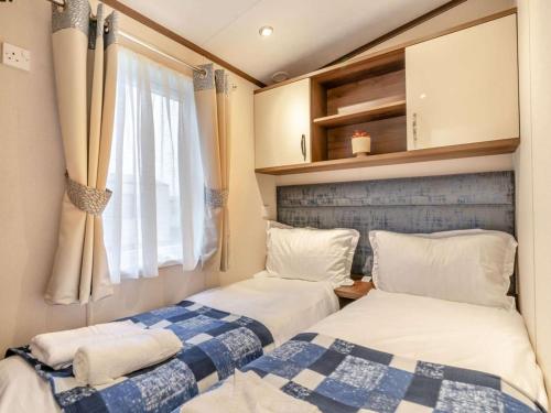 two beds in a small room with a window at 2 Bed in St. Andrews oc-90763 in St. Andrews