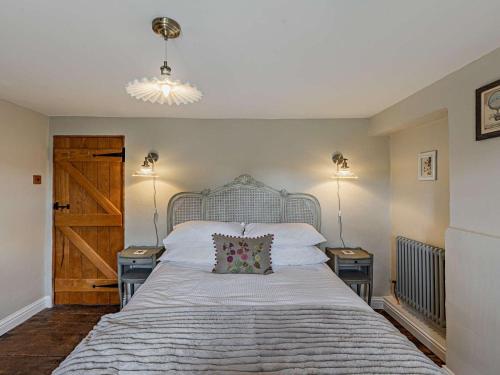 a bedroom with a large bed with two night stands at 1 Bed in Chipping Campden oc-93393 in Chipping Campden