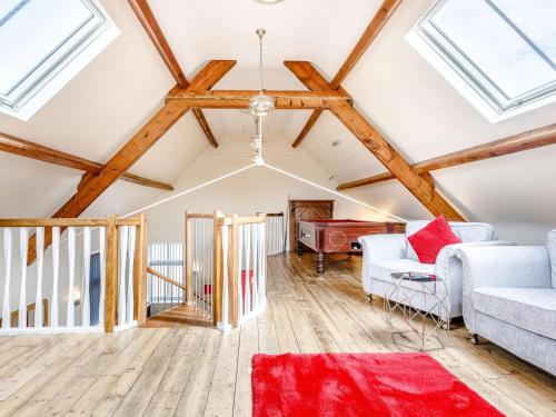 a living room with wooden ceilings and a red rug at 2 Bed in Ellesmere oc-62544 in Ellesmere