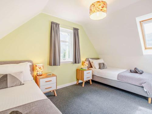 a twin bedroom with two beds and a window at 3 Bed in Callander oc-79359 in Callander