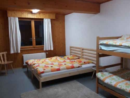 a bedroom with two bunk beds and a window at Maya Joie in La Fouly