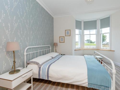 a bedroom with a white bed and a window at 4 Bed in Dunoon oc-79529 in Ardentinny