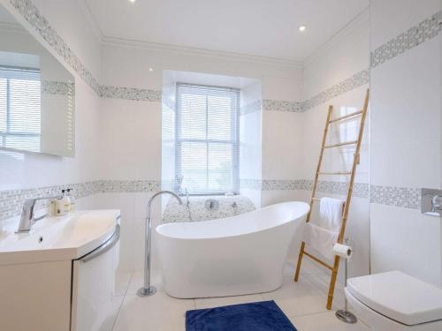 a bathroom with a tub and a sink and a ladder at 4 Bed in Dunoon oc-79529 in Ardentinny