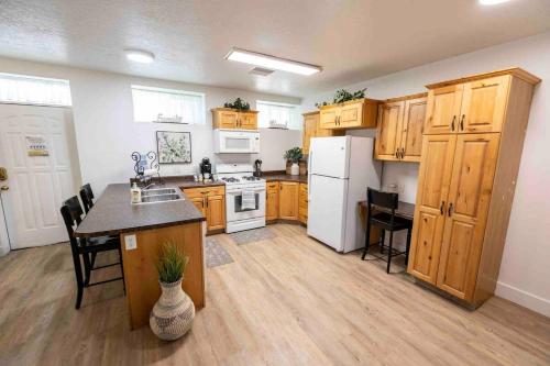 a kitchen with wooden cabinets and a white refrigerator at Maple Canyon w/Kitchen&wash+dry in Mount Pleasant