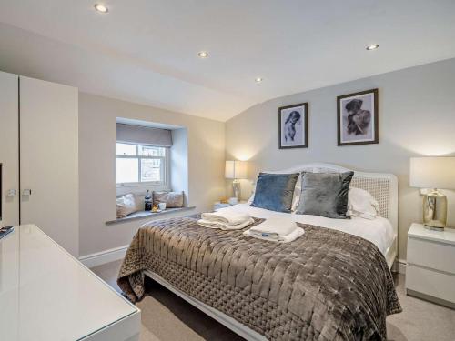 a bedroom with a bed with two towels on it at 2 Bed in Grange-over-sands oc-73154 in Cartmel