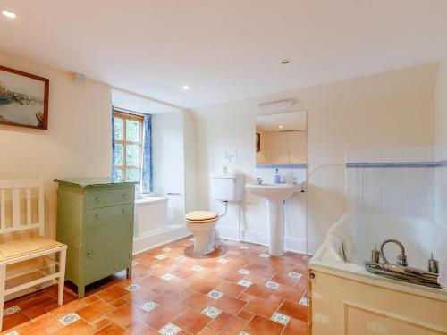 a bathroom with a sink and a toilet and a tub at 5 Bed in Blairgowrie oc-ca409 in Cray