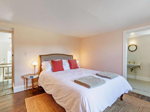 a bedroom with a large white bed with red pillows at 4 Bed in Leyburn oc-g0008 in Gammersgill