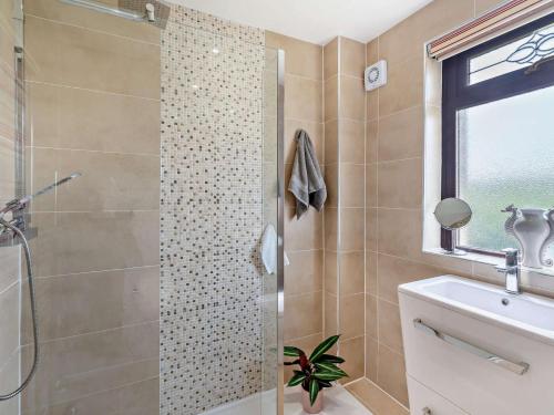 a bathroom with a shower and a toilet and a sink at 3 Bed in Falkirk oc-96124 in Avonbridge