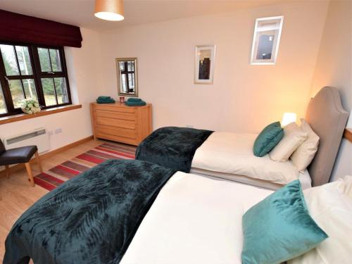 a bedroom with two beds and a dresser at 1 Bed in Lochgilphead oc-ca304 in Lochgilphead
