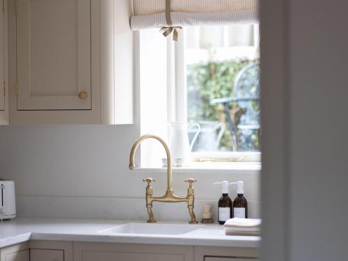 a white kitchen with a sink and a window at 1 Bed in Sedbergh oc-g0182 in Milnthorpe