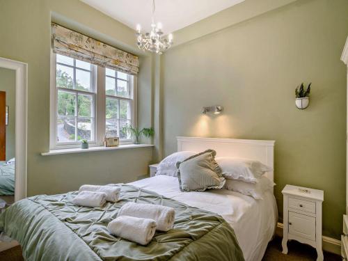 a bedroom with a bed with towels on it at 2 Bed in Ulverston oc-94926 in Lakeside