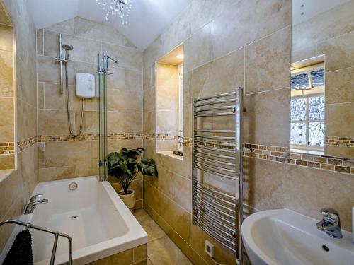 a bathroom with a sink and a shower and a tub at 2 Bed in Ulverston oc-94926 in Lakeside