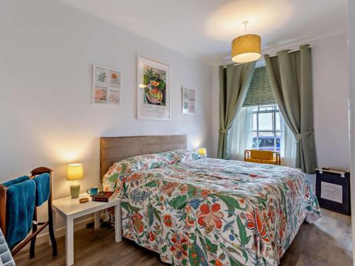 a bedroom with a bed and a table and a window at 1 Bed in Buckie oc-94536 in Cullen