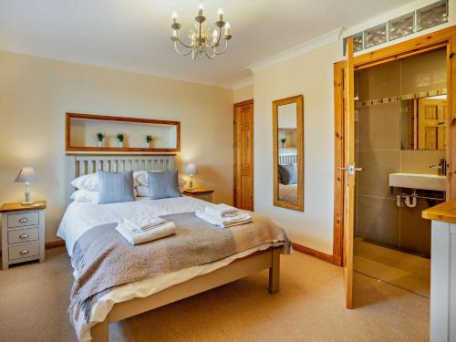 a bedroom with a bed and a bathroom with a sink at 3 Bed in Isle Of Arran oc-ca099 in Sliddery