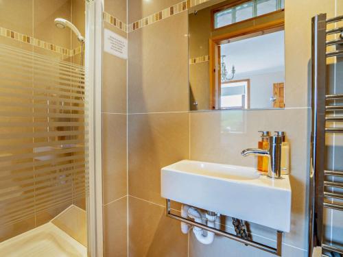 a bathroom with a sink and a shower at 3 Bed in Isle Of Arran oc-ca099 in Sliddery