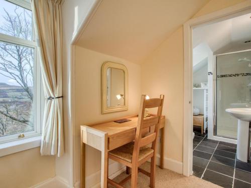 a home office with a wooden desk and a window at 4 Bed in Isle Of Skye oc-ca363 in Glendale