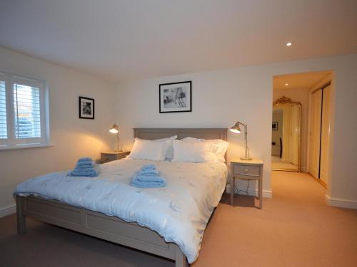 a bedroom with a bed with two towels on it at 3 Bed in Tetbury oc-44955 in Tetbury