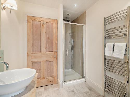 a bathroom with a sink and a glass shower at 2 Bed in Grange-over-sands oc-83546 in Cartmel