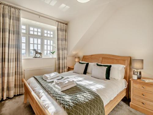 a bedroom with a bed with two towels on it at 2 Bed in Grange-over-sands oc-83546 in Cartmel
