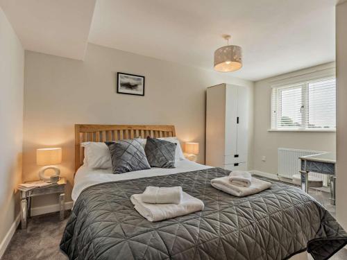 a bedroom with a large bed with two towels on it at 2 Bed in Grange-over-sands oc-89206 in Cartmel