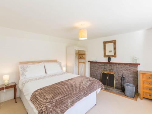 a bedroom with a bed and a fireplace at 2 Bed in Gairloch oc-ca137 in Big Sand
