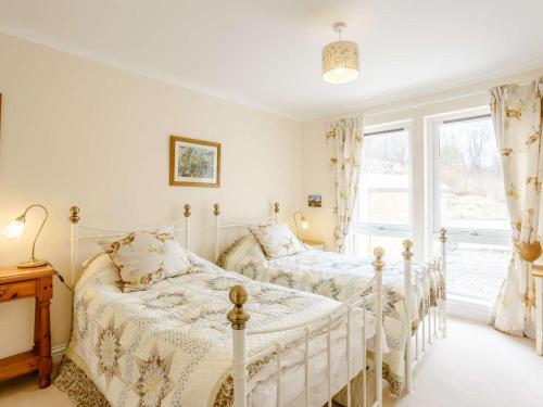 two beds in a bedroom with a window at 3 Bed in Isle Of Skye oc-81181 in Luib