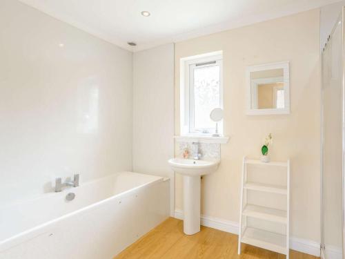 a white bathroom with a sink and a bath tub at 3 Bed in Isle Of Skye oc-81181 in Luib