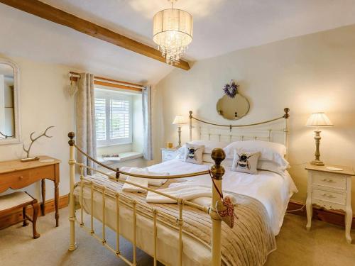 a bedroom with a bed and a desk and a mirror at 1 Bed in Grange-over-sands oc-89364 in Cartmel