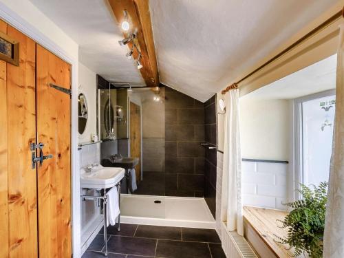 a bathroom with a tub and a sink and a shower at 1 Bed in Grange-over-sands oc-89364 in Cartmel