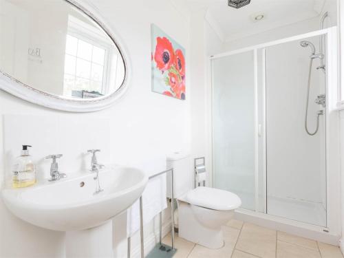 a white bathroom with a sink and a mirror at 1 Bed in Brechin oc-ca217 in Edzell
