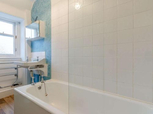 a white bathroom with a tub and a sink at 2 Bed in Anstruther oc-ca006 in Crail