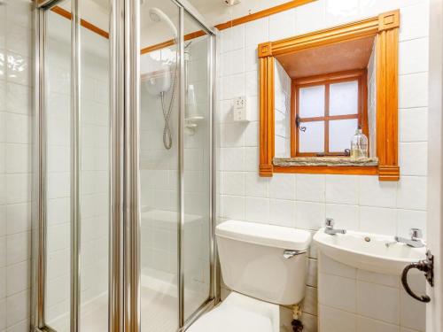 a bathroom with a shower and a toilet and a sink at 1 Bed in Isle Of Skye oc-ca073 in Glendale