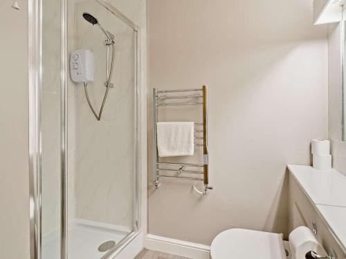 a white bathroom with a shower and a toilet at 3 Bed in Penrith oc-85896 in Penruddock