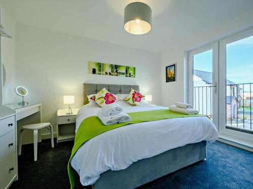 a bedroom with a bed with a desk and a window at 4 Bed in Penrith oc-89353 in Little Salkeld