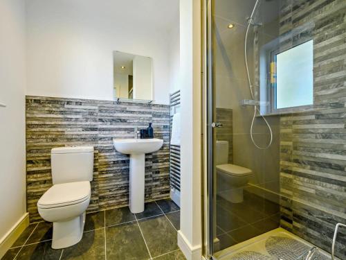 a bathroom with a toilet and a sink and a shower at 4 Bed in Penrith oc-89353 in Little Salkeld
