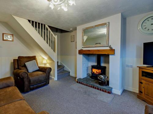 a living room with a fireplace and a television at 2 Bed in Ludlow oc-91422 in Ludlow