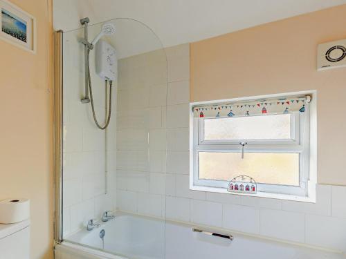 a bathroom with a bath tub and a window at 2 Bed in Ludlow oc-91422 in Ludlow