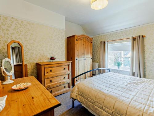 a bedroom with a bed and a dresser and a window at 2 Bed in Ludlow oc-91422 in Ludlow