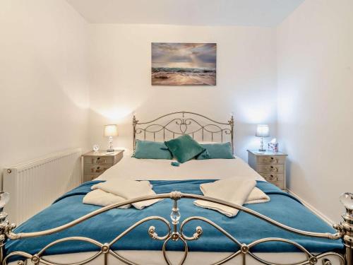 a bedroom with a large bed with blue sheets at 2 Bed in Morecambe oc-93719 in Heysham